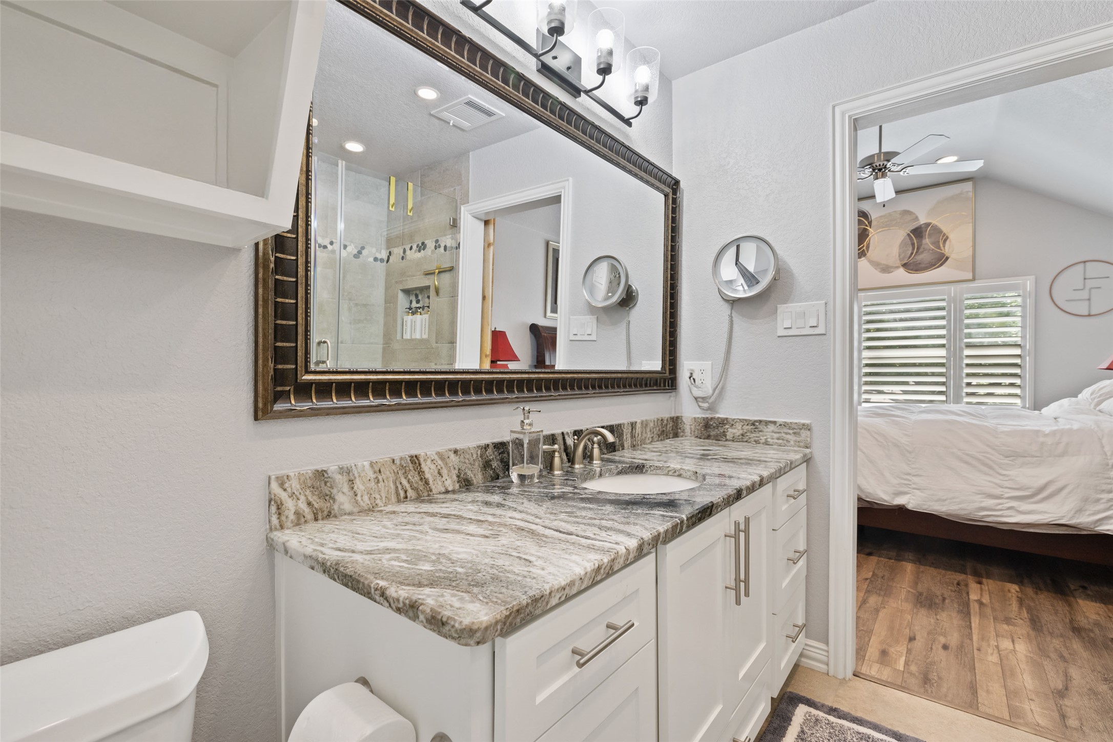 134 Prairie Springs Cove Georgetown, TX 78626 - Photo 23 of 34 a en suite bathroom with a granite countertop sink and a mirror