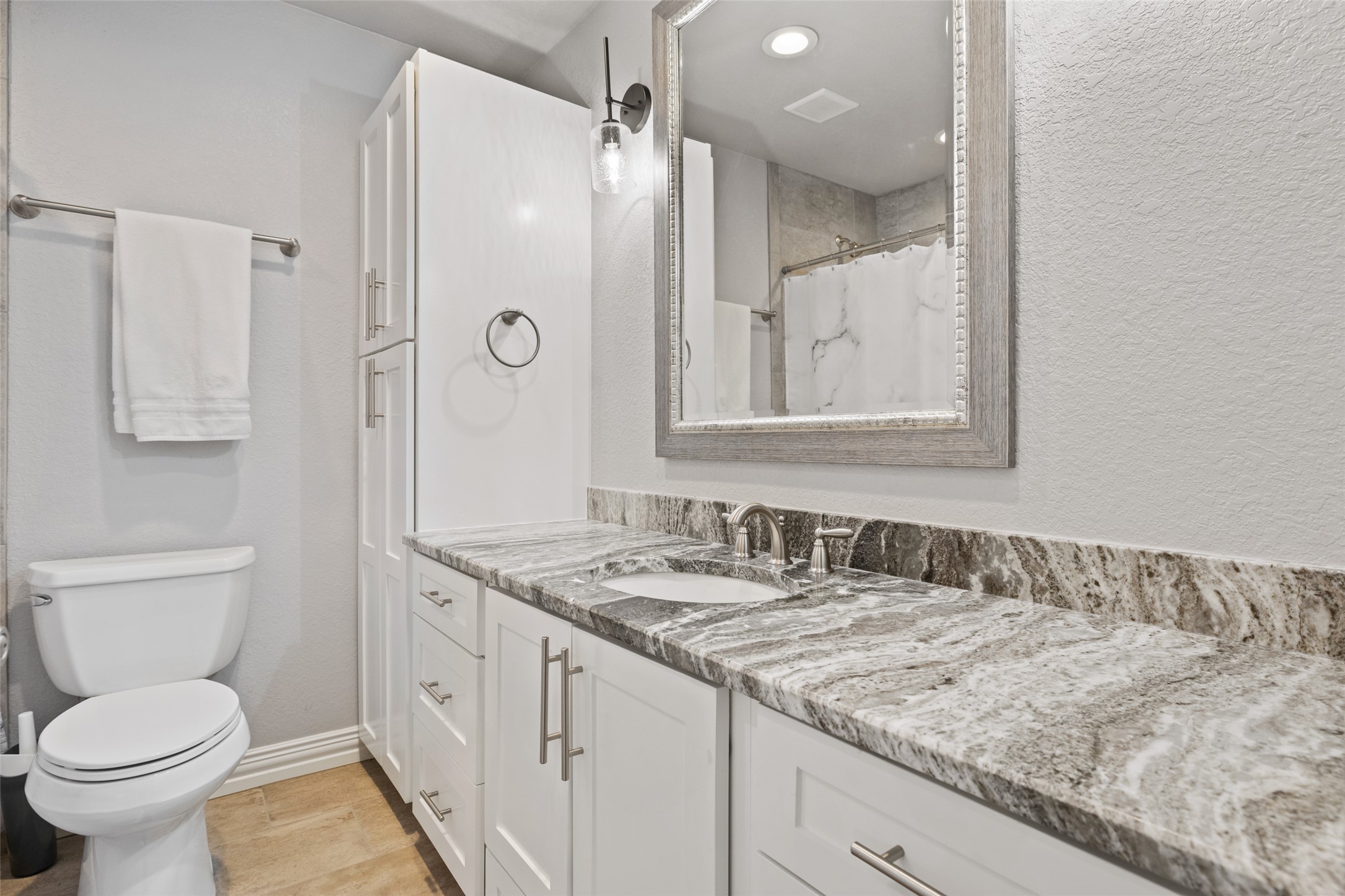 134 Prairie Springs Cove Georgetown, TX 78626 - Photo 24 of 34 a bathroom with a granite countertop sink toilet and shower