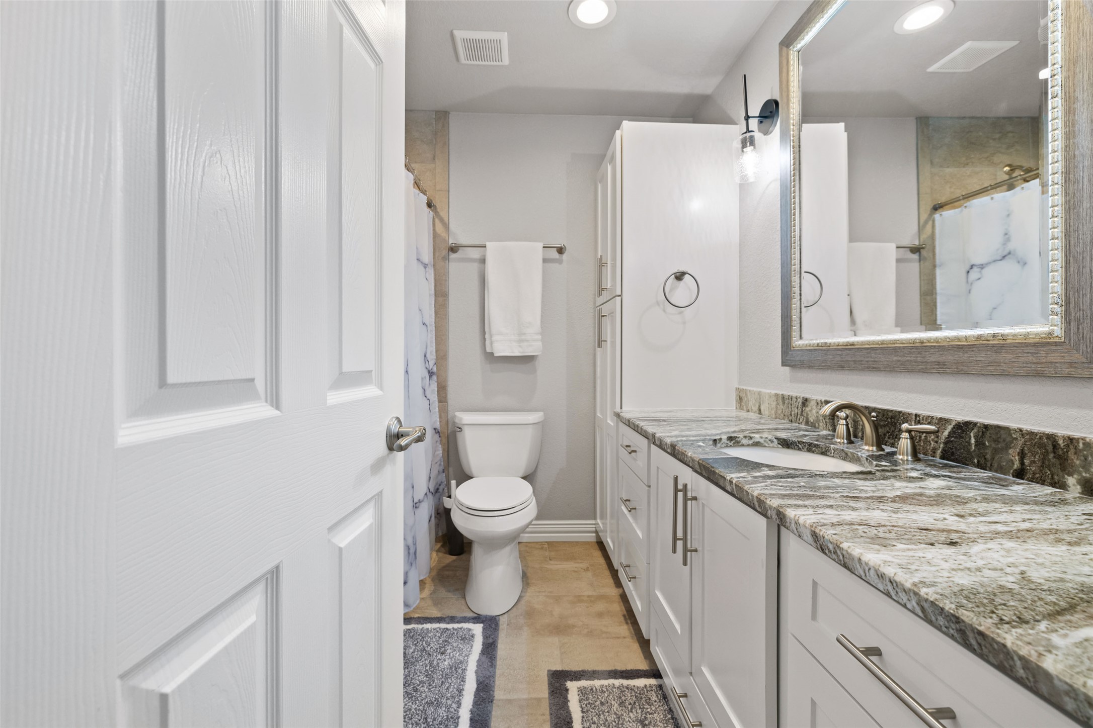 134 Prairie Springs Cove Georgetown, TX 78626 - Photo 25 of 34 a bathroom with a granite countertop sink toilet and shower