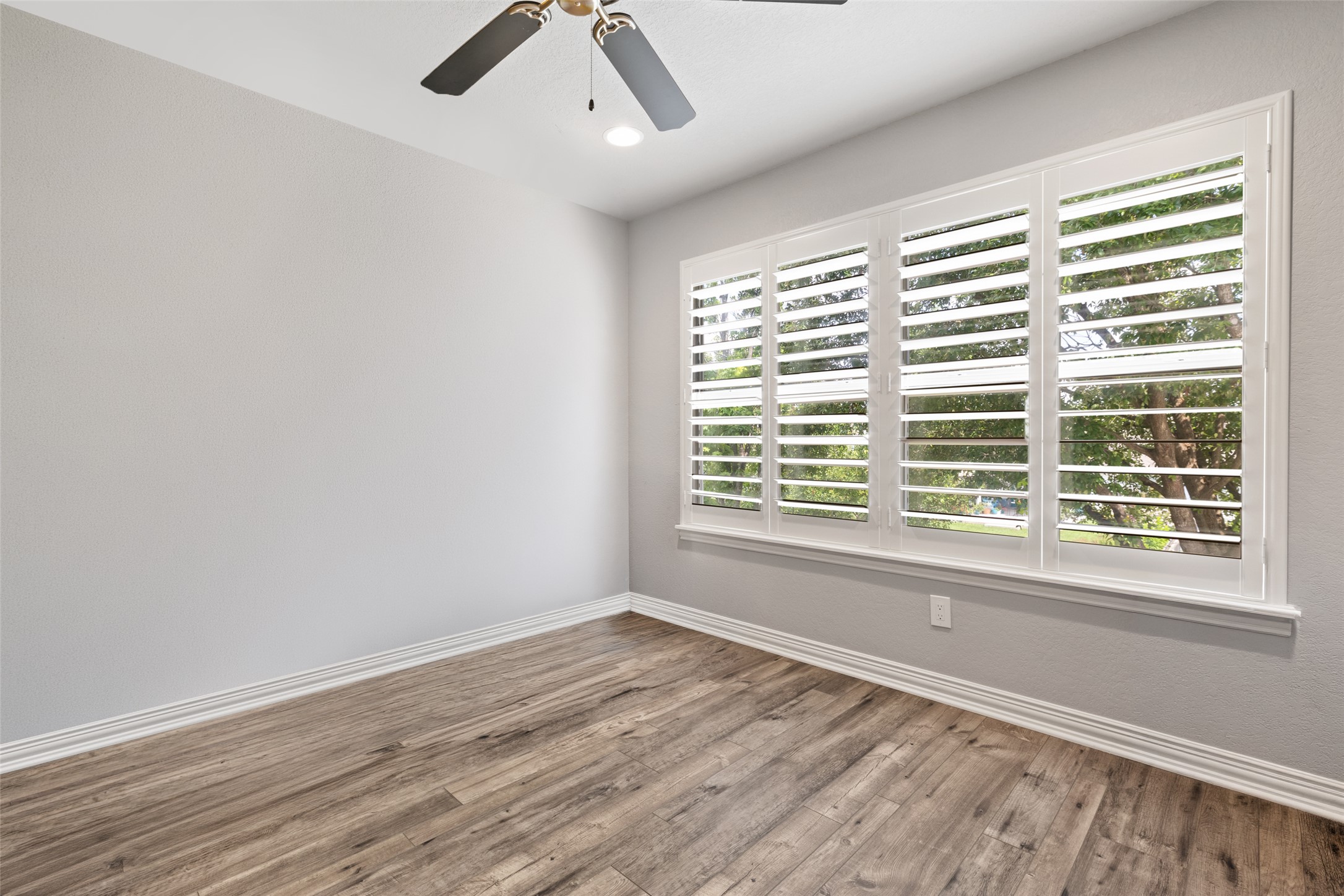 134 Prairie Springs Cove Georgetown, TX 78626 - Photo 30 of 34 a view of an empty room with wooden floor and a window