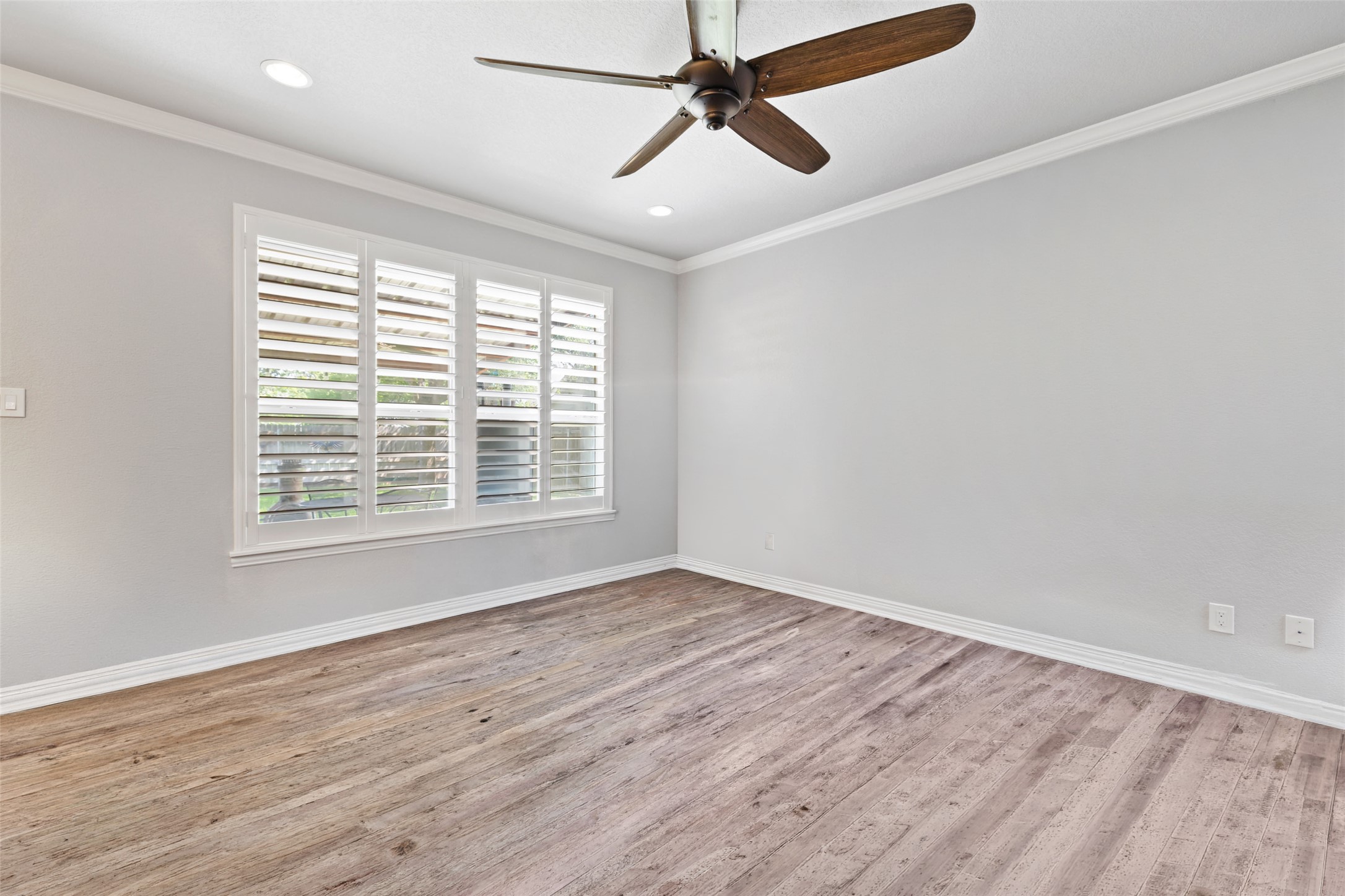 134 Prairie Springs Cove Georgetown, TX 78626 - Photo 5 of 34 a view of an empty room with wooden floor and a window