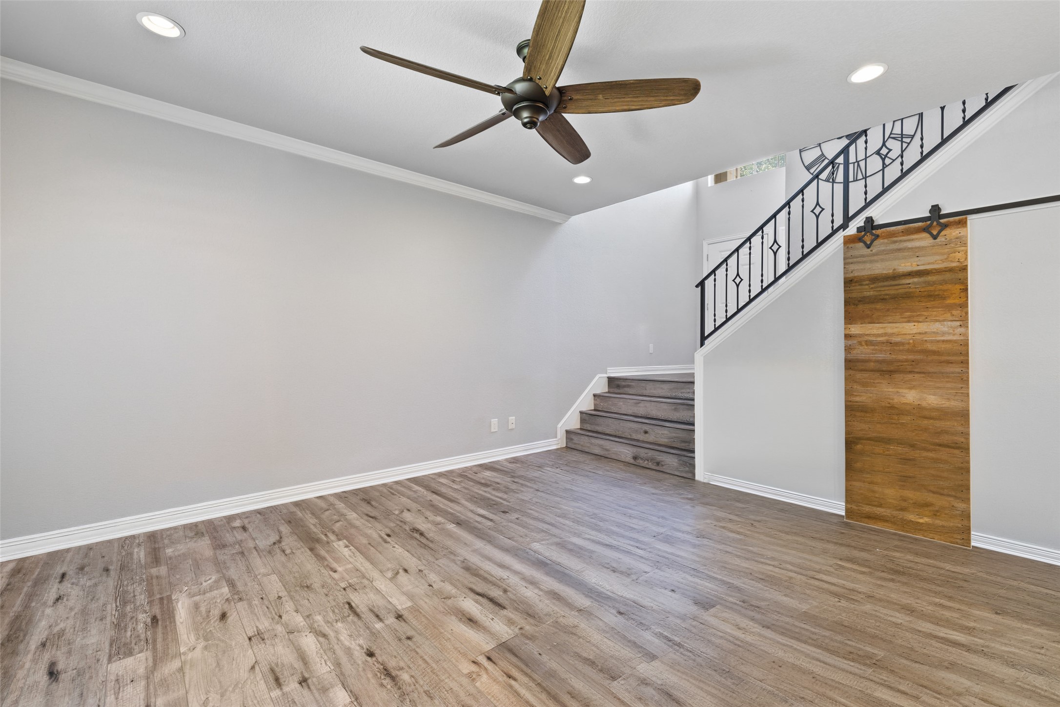 134 Prairie Springs Cove Georgetown, TX 78626 - Photo 6 of 34 a view of empty room with wooden floor and fan