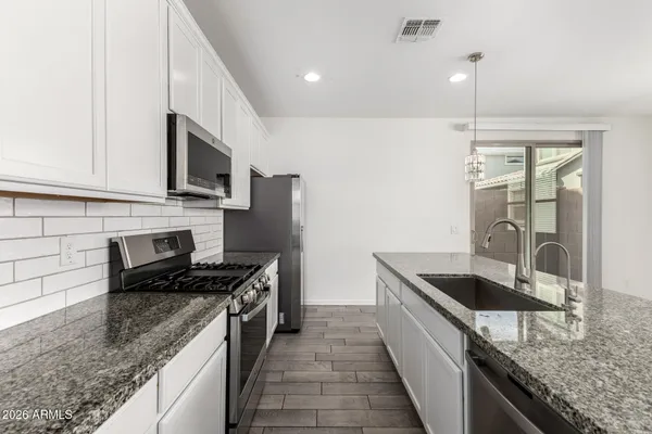 an empty room with closet and windows