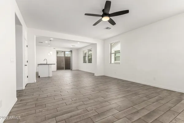 a front view of a house with a yard and potted plants