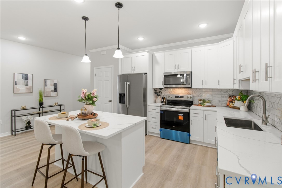 1430 Decatur Street Richmond, VA 23224 - Photo 12 of 37 Open-concept kitchen featuring an island with seat