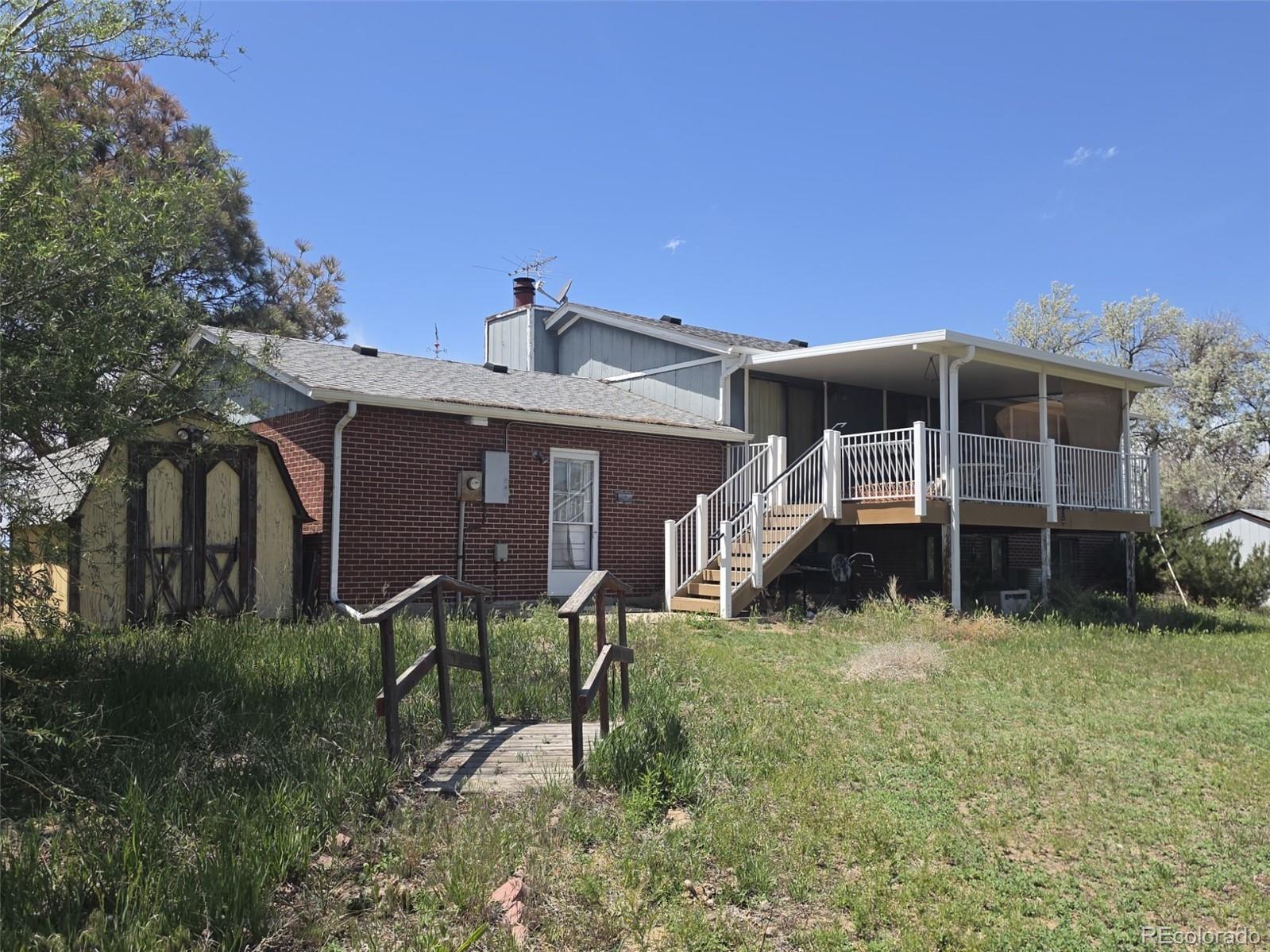 15690 Gun Club Road Brighton, CO 80603 - Photo 27 of 31 a view of a house with a yard