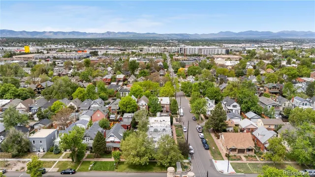 an aerial view of residential building with outdoor space and trees
