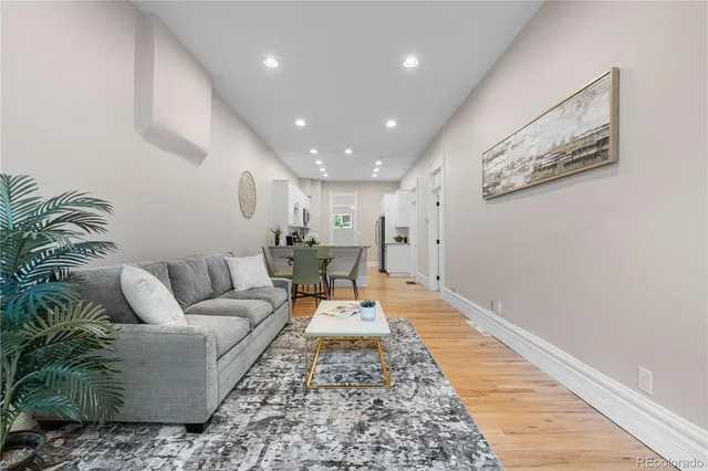 a living room with furniture and a rug