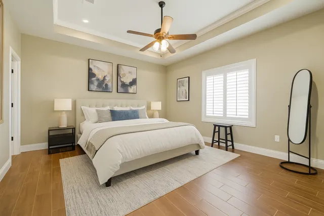 a bedroom with a bed and a chandelier