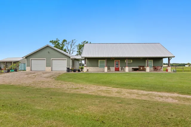 a front view of a house with a garden and porch