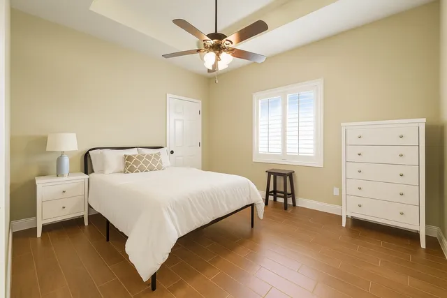 a bedroom with a bed and a chandelier