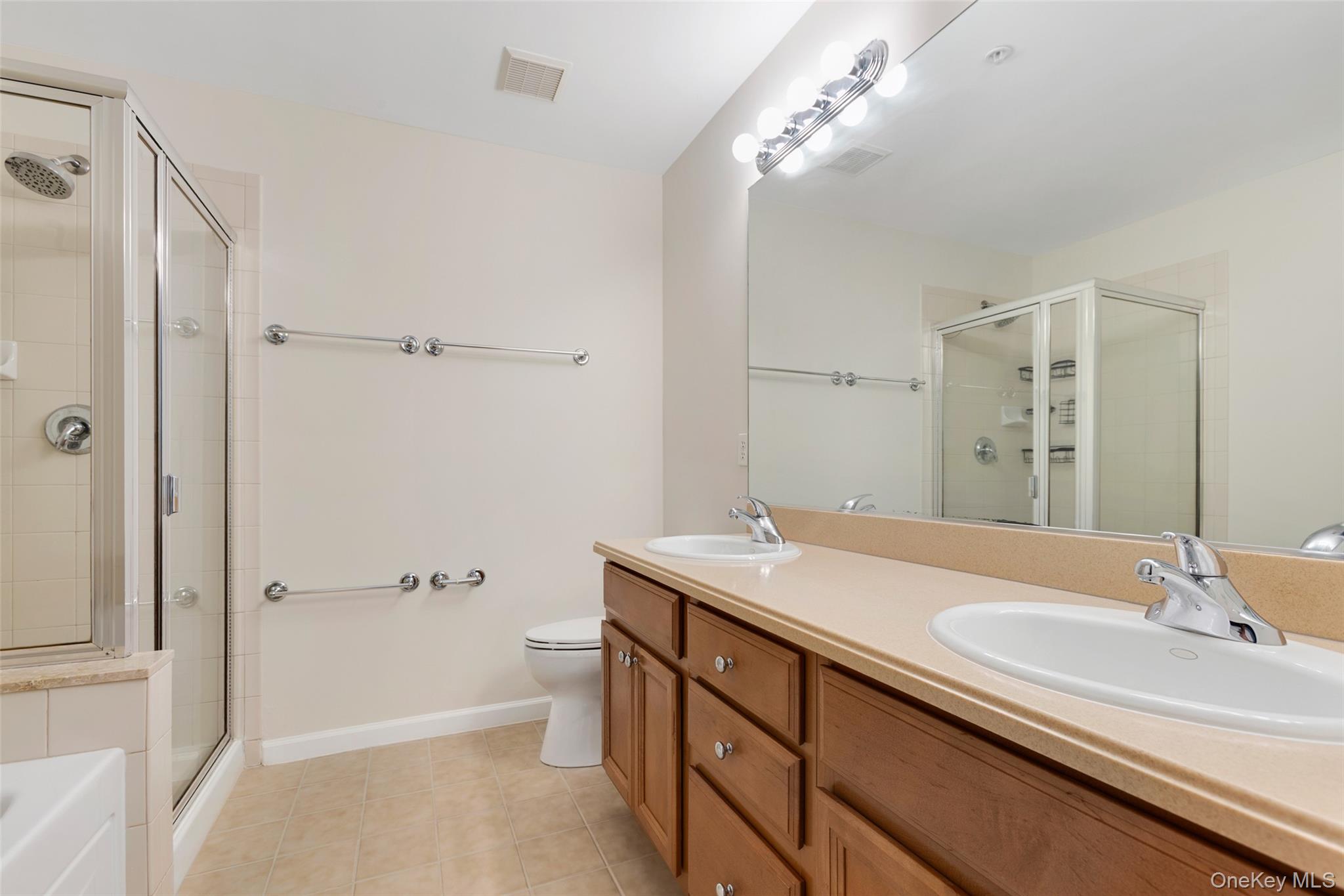 223 Viewpoint Terrace Peekskill, NY 10566 - Photo 14 of 30 Bathroom featuring a shower stall, double vanity, light tile patterned flooring, and a bath