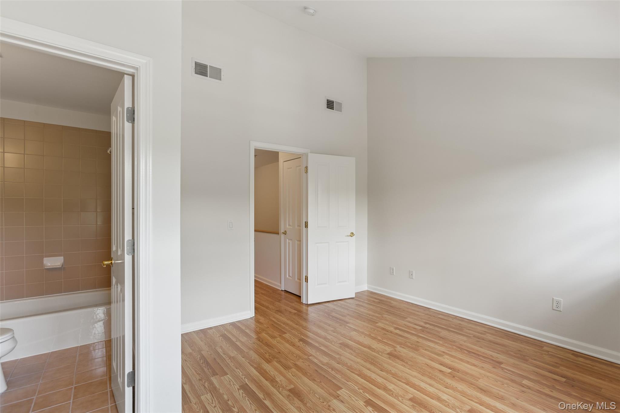 223 Viewpoint Terrace Peekskill, NY 10566 - Photo 18 of 30 Unfurnished bedroom with a towering ceiling and light wood finished floors