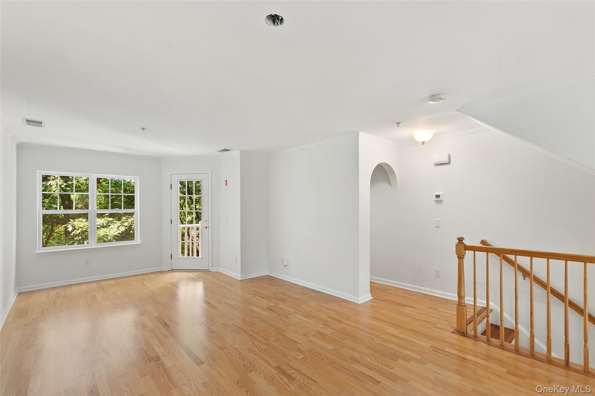 223 Viewpoint Terrace Peekskill, NY 10566 - Photo 3 of 30 Empty room with light wood-style floors and arched walkways