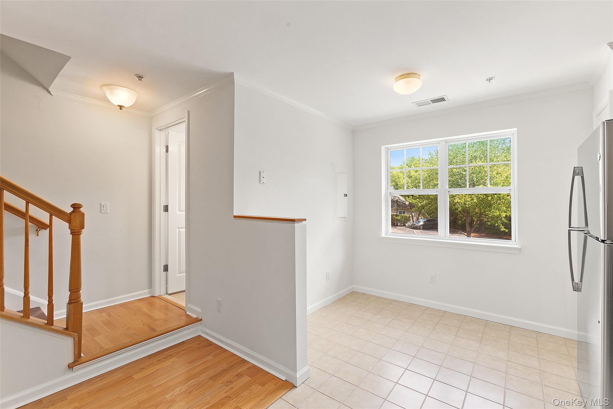 223 Viewpoint Terrace Peekskill, NY 10566 - Photo 9 of 30 Spare room featuring ornamental molding, stairway, and light wood finished floors