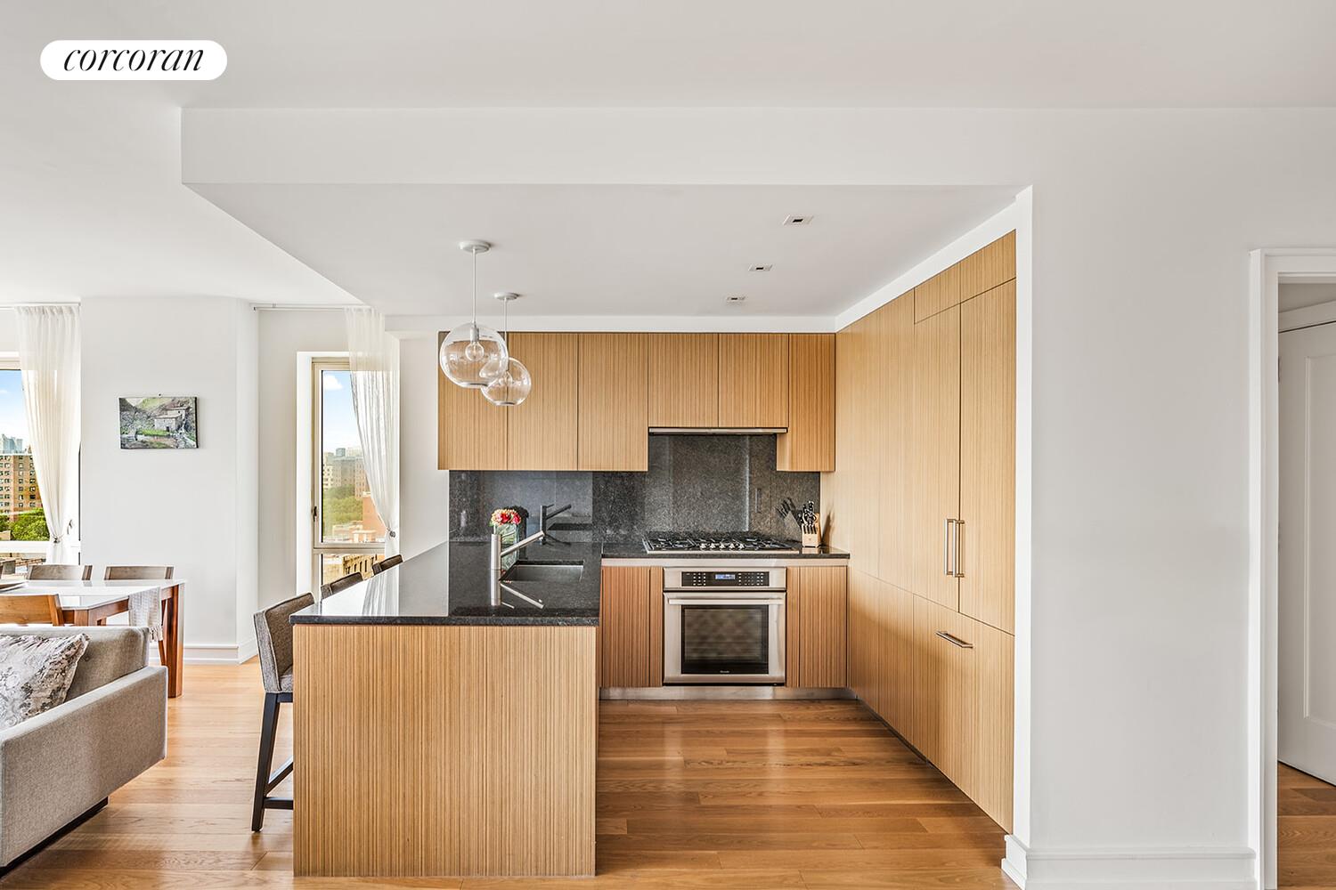 1280 5th Avenue, Unit 11A Manhattan, NY 10029 - Photo 3 of 22 a kitchen with stainless steel appliances a sink a stove a refrigerator cabinets and a dining table