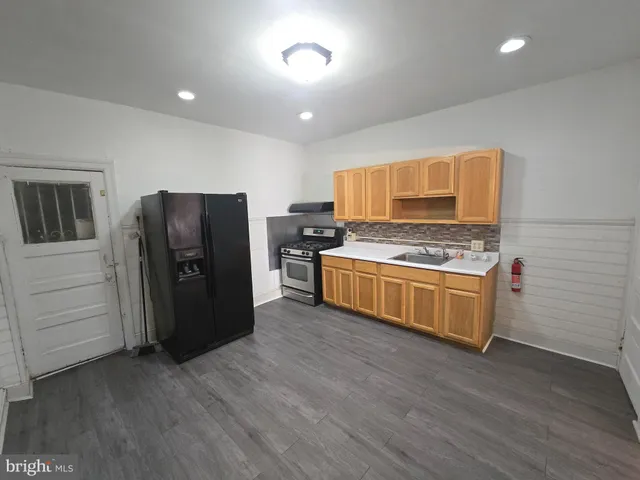 a kitchen with stainless steel appliances a refrigerator and a stove top oven