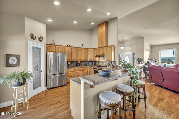 a kitchen with stainless steel appliances granite countertop a refrigerator and a stove top oven