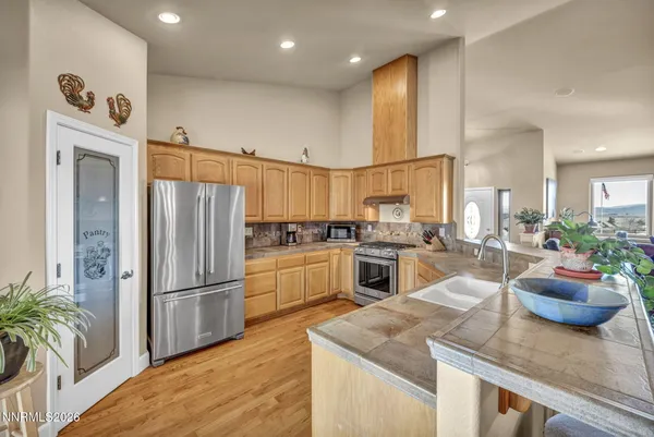 a kitchen with stainless steel appliances granite countertop a stove and a sink