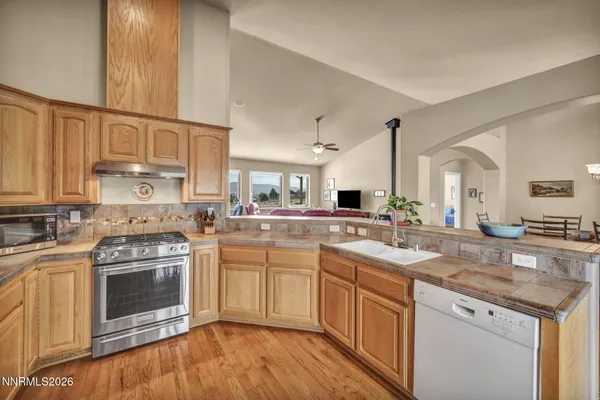 a view of a dining room with furniture a chandelier and wooden floor