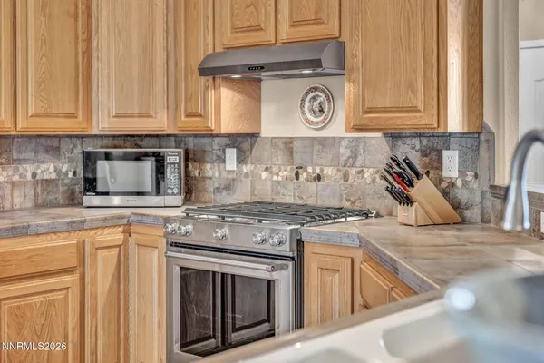 a spacious bedroom with a bed and a chandelier