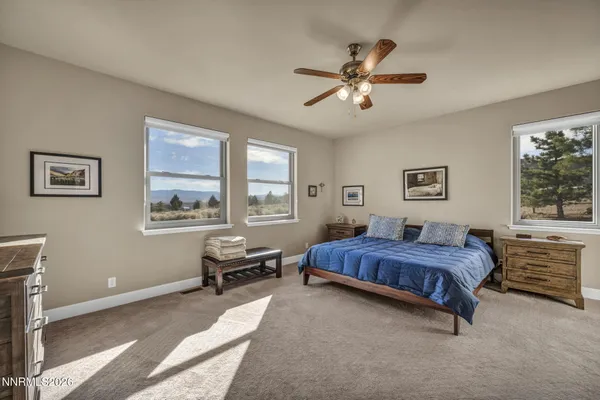 a view of a workspace with furniture and a ceiling fan