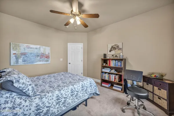 a view of a dry yard with wooden fence