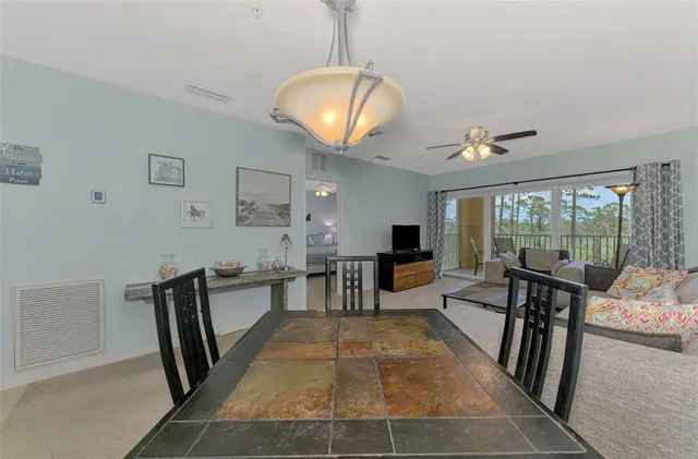 a kitchen with granite countertop a sink stainless steel appliances and white cabinets