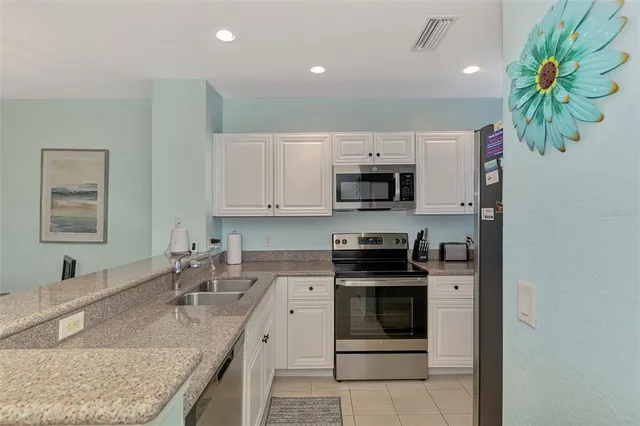 a spacious bathroom with a granite countertop sink a mirror and a shower