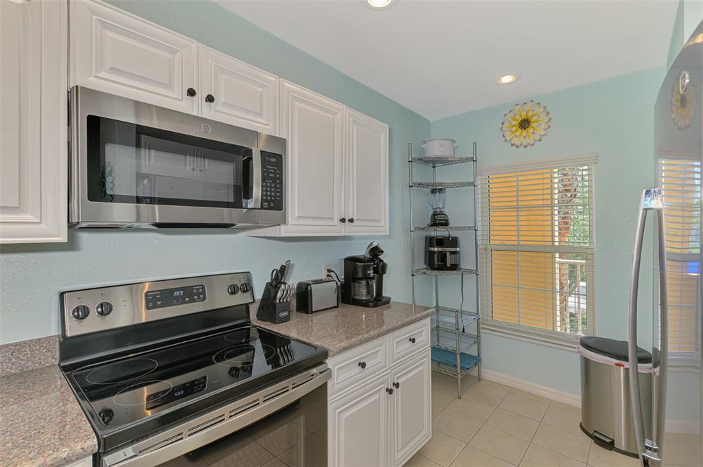 8409 Placida Road, Unit 206 Placida, FL 33946 - Photo 22 of 67 a kitchen with appliances a sink and cabinets
