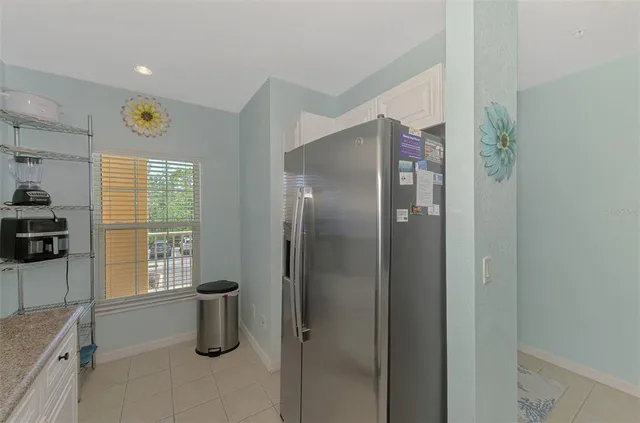 a view of a bedroom with a bed and a chandelier fan