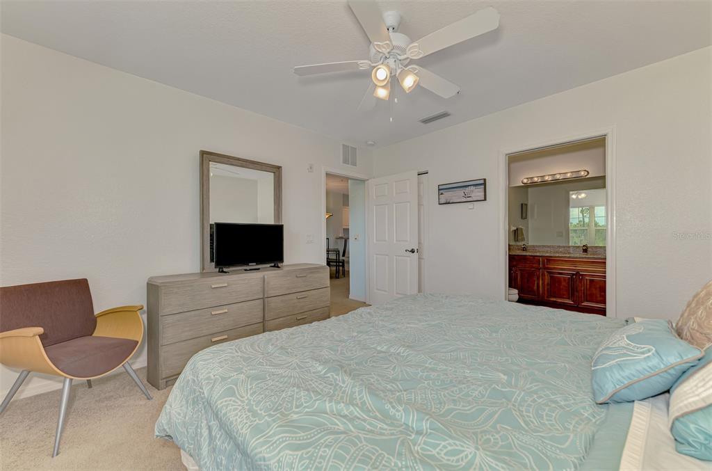 8409 Placida Road, Unit 206 Placida, FL 33946 - Photo 30 of 67 a spacious bedroom with a bed and a chair