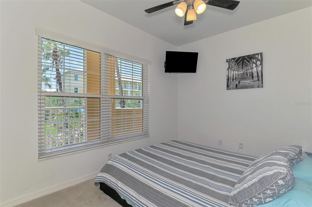 8409 Placida Road, Unit 206 Placida, FL 33946 - Photo 32 of 67 a bedroom with a bed and a chandelier