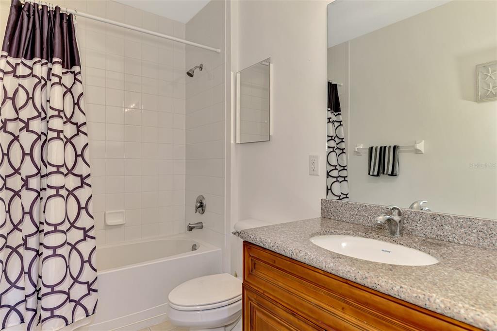8409 Placida Road, Unit 206 Placida, FL 33946 - Photo 34 of 67 a bathroom with a granite countertop sink toilet and shower
