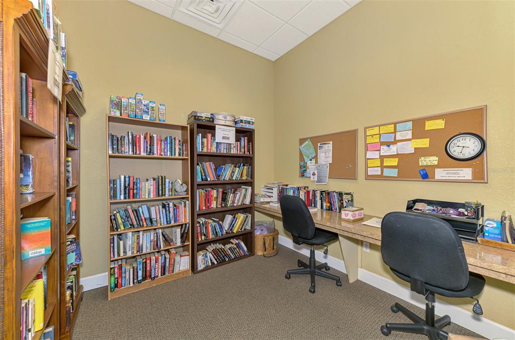8409 Placida Road, Unit 206 Placida, FL 33946 - Photo 57 of 67 a view of a workspace with furniture and a bookshelf