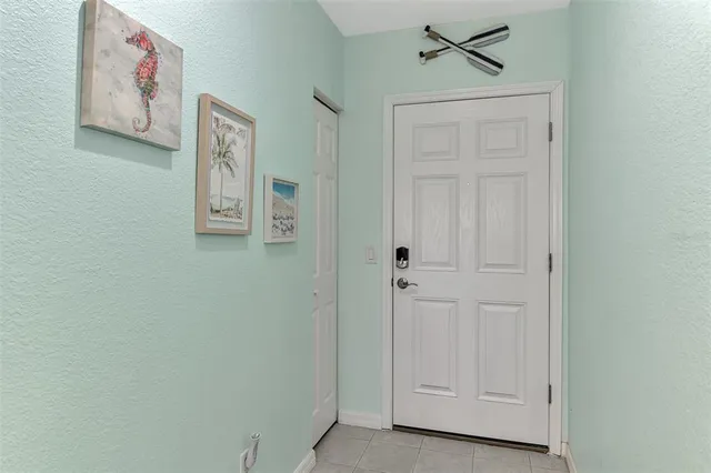 a living room with furniture a flat screen tv and a floor to ceiling window
