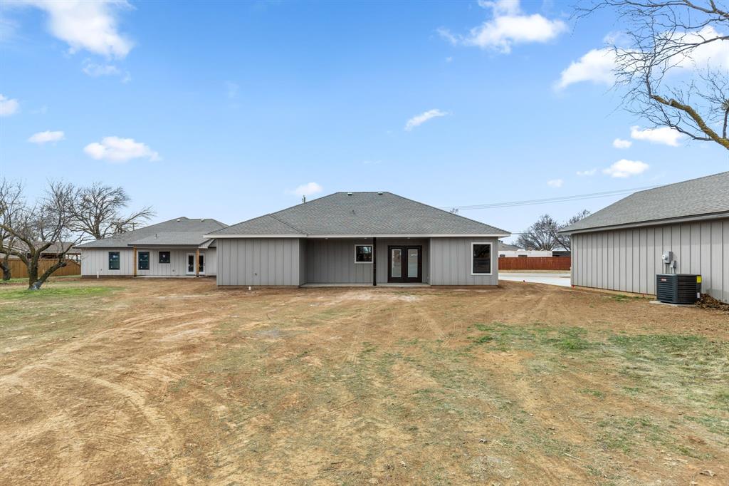 4695 Sisk Road Wichita Falls, TX 76310 - Photo 32 of 32 Back of property featuring central AC and a lawn