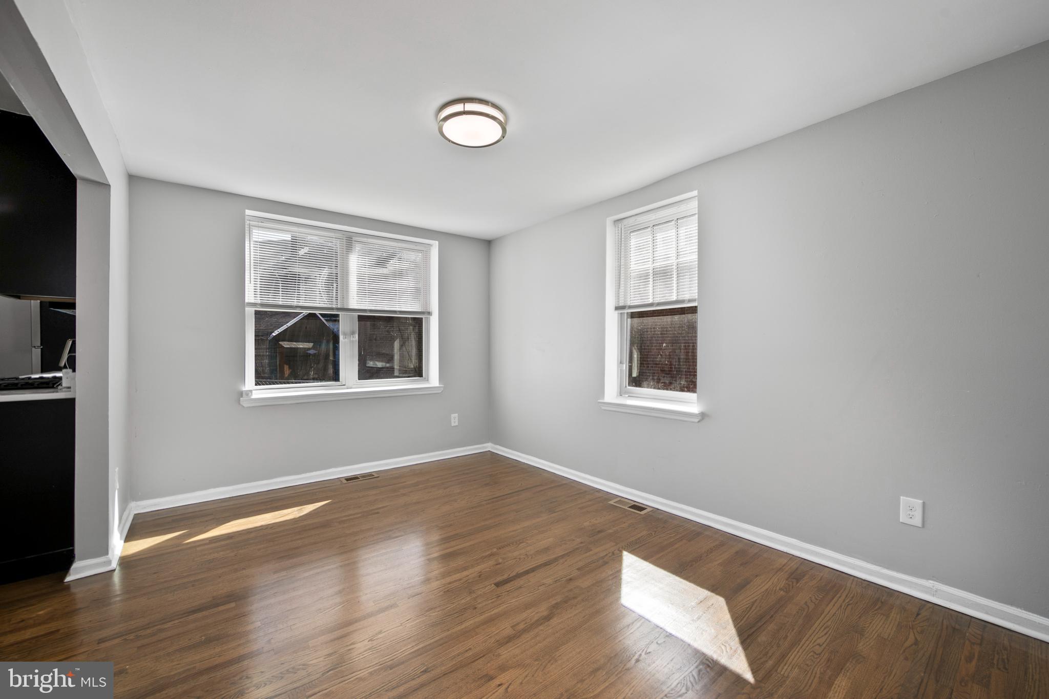 1226 America Road Camden, NJ 08104 - Photo 8 of 30 a view of an empty room with wooden floor and a window