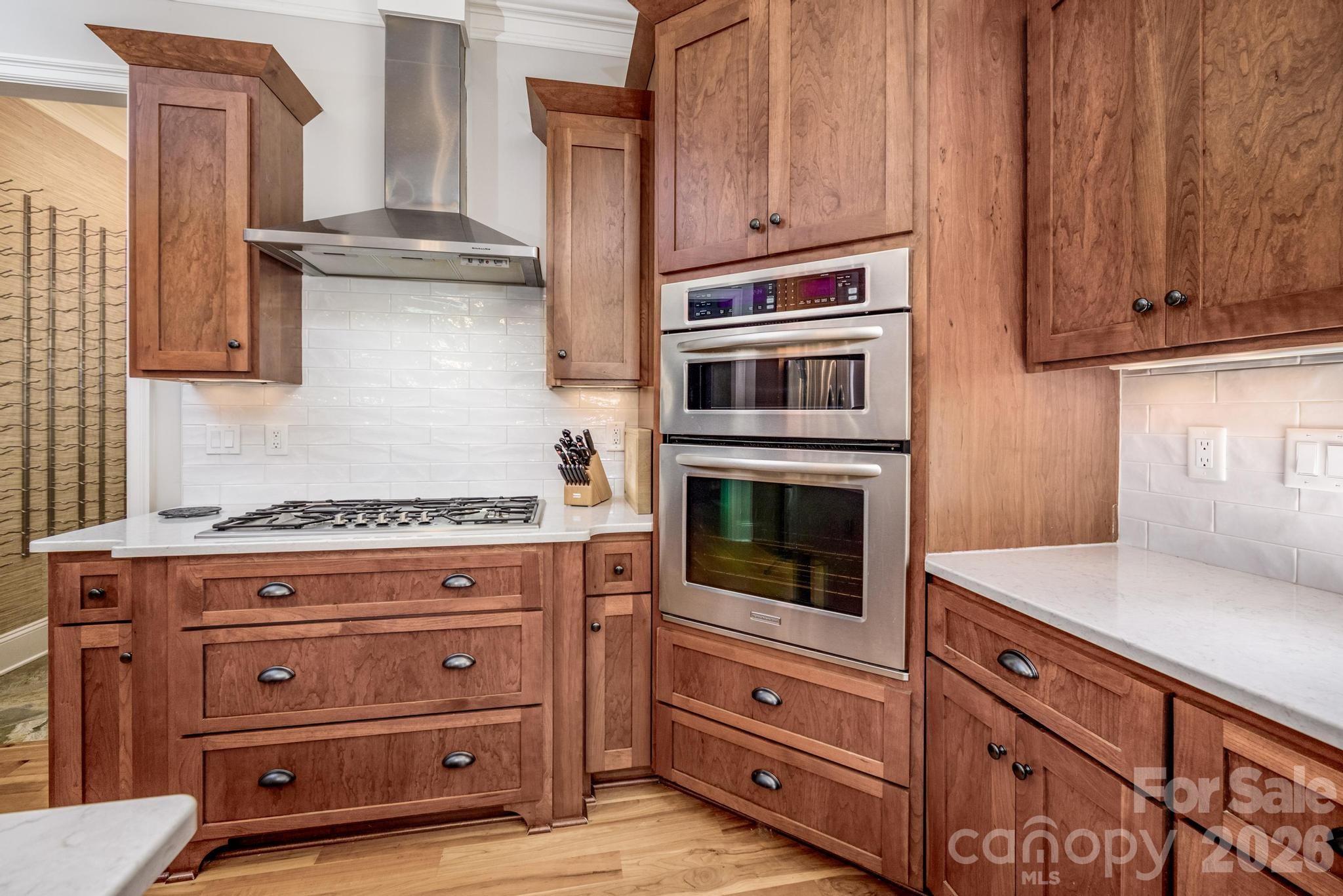 7315 Bay Ridge Drive Denver, NC 28037 - Photo 11 of 39 a kitchen with granite countertop cabinets and oven a stove with wooden floor
