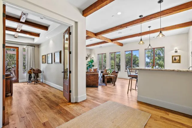 a view of a livingroom with furniture window and wooden floor