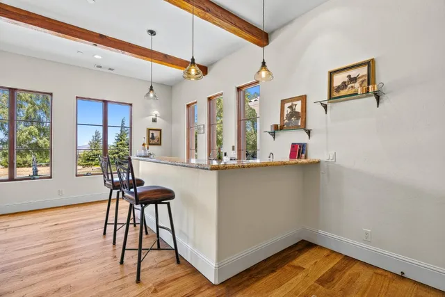 a view of a kitchen with dining table and chairs