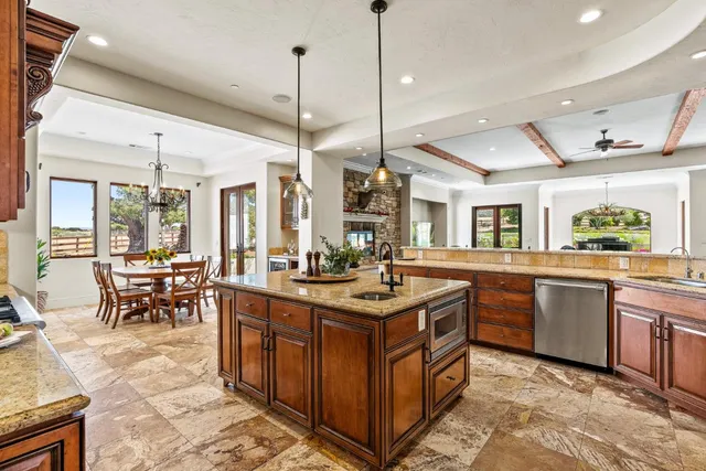 a spacious bedroom with a bed and a chandelier