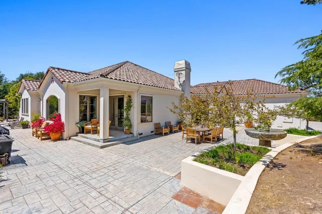 a living room with furniture a fireplace and a large window