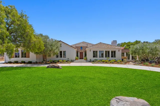 a front view of a house with yard porch and furniture