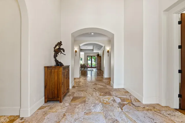a living room with furniture a wooden floor and a large window