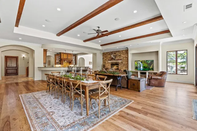 a dining room with furniture window and wooden floor