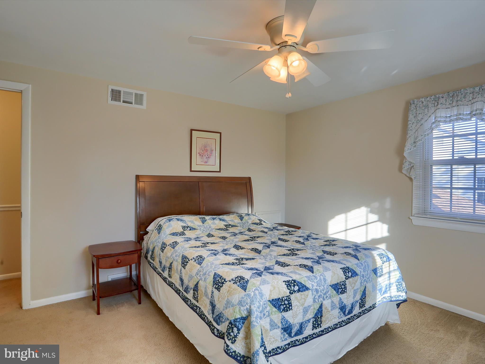 5256 Strathmore Drive Mechanicsburg, PA 17050 - Photo 22 of 47 a bedroom with a bed and a chandelier