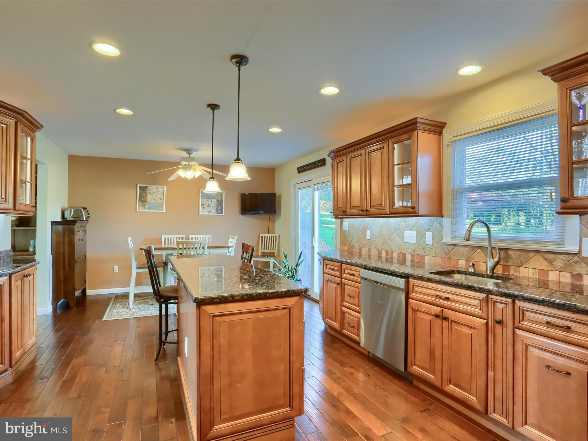 5256 Strathmore Drive Mechanicsburg, PA 17050 - Photo 9 of 47 a kitchen with stainless steel appliances granite countertop wooden floors and sink