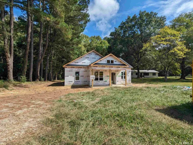 a front view of a house with yard