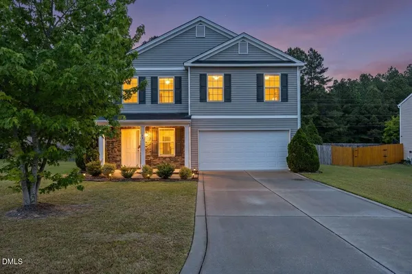 a front view of a house with a yard